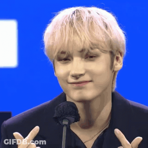 Blonde Man Giving Peace Sign At Microphone GIF
