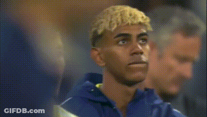 Blonde Man Next To Man In Blue Shirt GIF