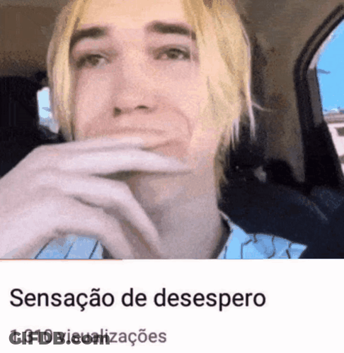 Blonde Man Sitting In Car With Hand Over Mouth GIF