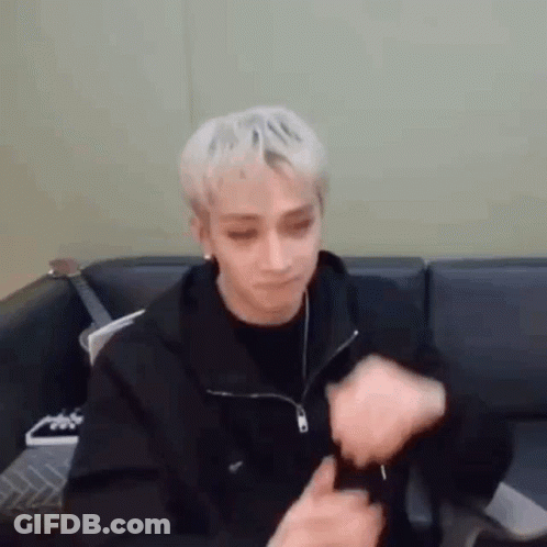 Blonde Man Sitting On Couch With Hands On Face GIF