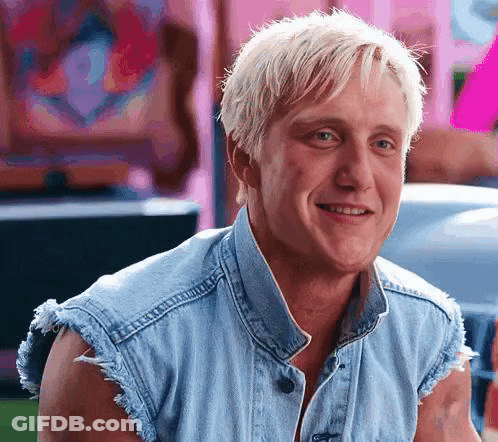 Blonde Man Smiling In Denim Vest GIF