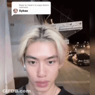 Blonde Man Standing In Front Of Building Looking At Camera GIF