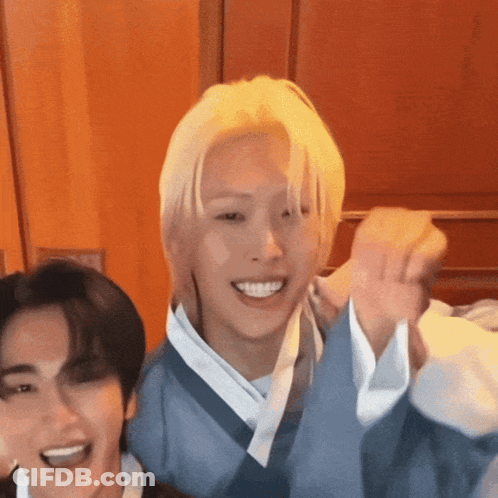 Blonde Man Standing Next To Man In Blue Kimono GIF