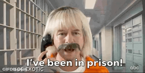 Blonde Man With Mustache Talking On Cell Phone In Prison GIF