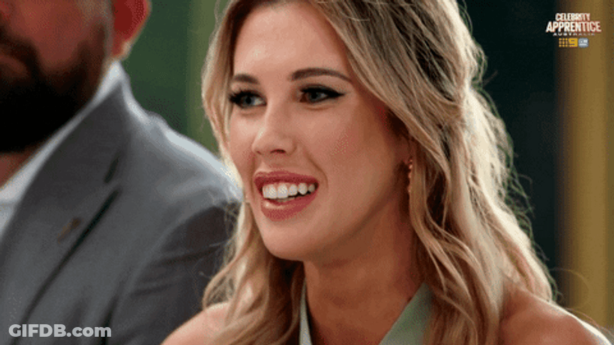 Blonde Smiles Then Straight Face GIF