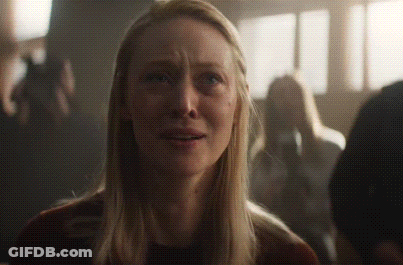 Blonde Woman Crying In Dark Crowd GIF