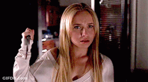 Blonde Woman Holding Knife In Dark Room GIF