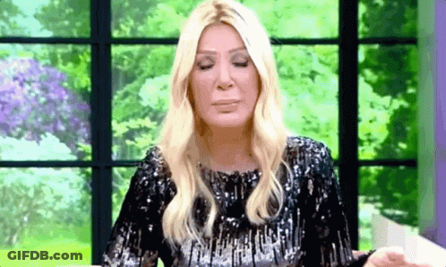 Blonde Woman In Black Sequined Dress Sitting GIF