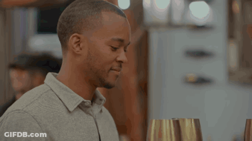 Blonde Woman In Black Top In Front Of Netflix Logo GIF