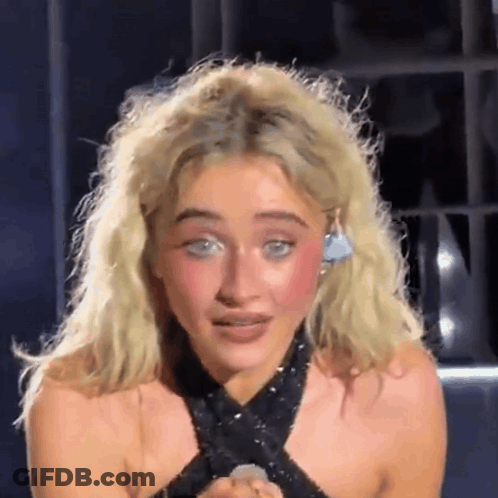Blonde Woman In Black Top With Earrings GIF