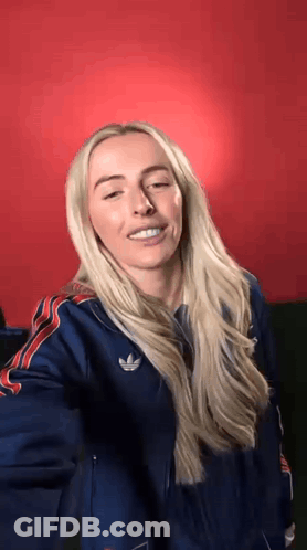 Blonde Woman In Blue Adidas Jacket Making Funny Face GIF