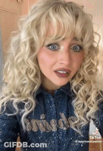Blonde Woman In Denim Shirt Making Funny Face GIF