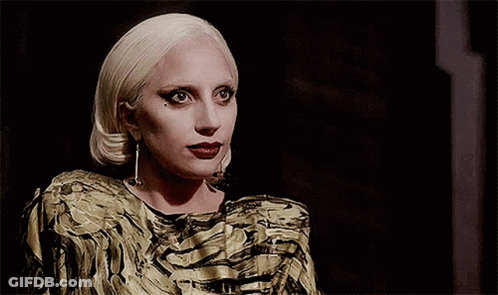 Blonde Woman In Gold And Black Dress GIF