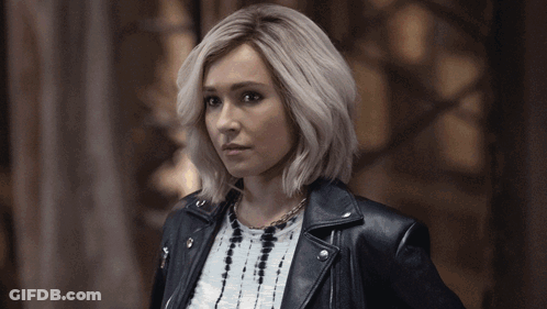 Blonde Woman In Leather Jacket And Necklace GIF