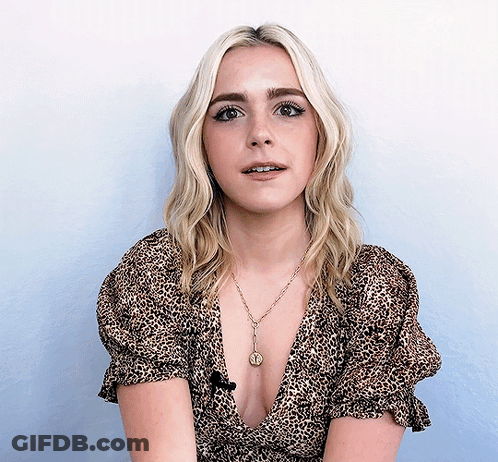 Blonde Woman In Leopard Top With Coin Necklace GIF