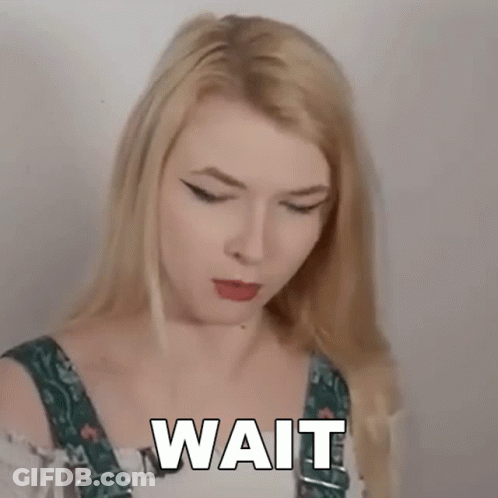 Blonde Woman In Overalls Making Funny Face Saying Wait GIF