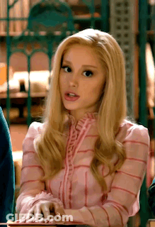 Blonde Woman In Pink Striped Shirt Sitting At Table GIF