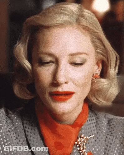 Blonde Woman In Polka Dot Suit And Red Scarf GIF