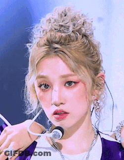 Blonde Woman In Purple Jacket And White Shirt GIF