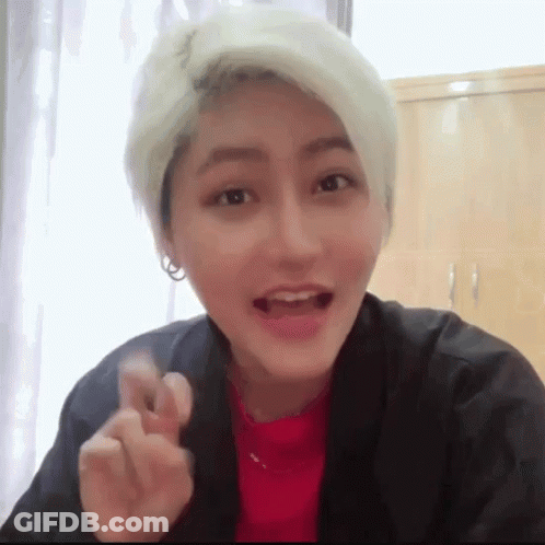 Blonde Woman In Red And Black Making Heart GIF
