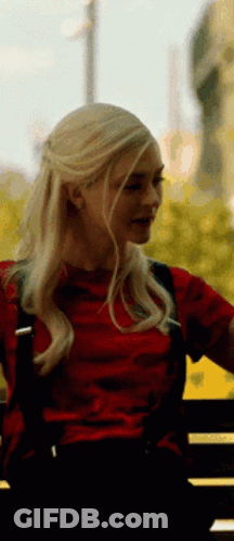 Blonde Woman In Red Shirt Sitting On Bench GIF