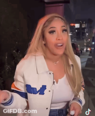 Blonde Woman In White Jacket With Letter M GIF