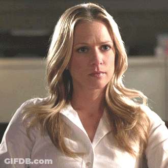 Blonde Woman In White Shirt Looking At Camera GIF