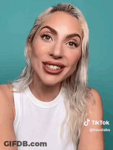 Blonde Woman In White Tank Top Smiling GIF