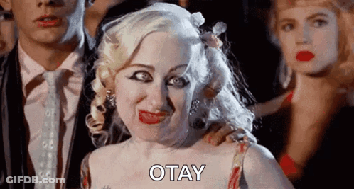 Blonde Woman Making Funny Face Next To Man And Woman GIF