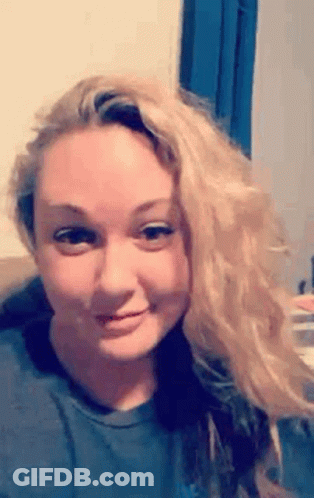 Blonde Woman Making Funny Face On Couch GIF