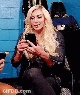 Blonde Woman Sitting In Chair Holding Cell Phone GIF