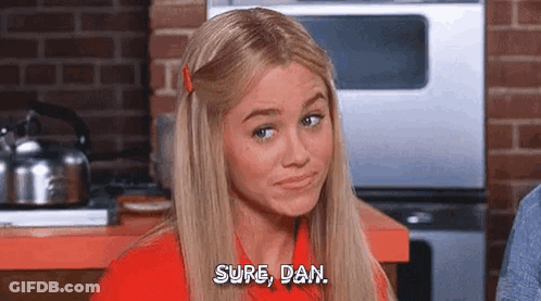Blonde Woman Sitting In Kitchen Talking GIF
