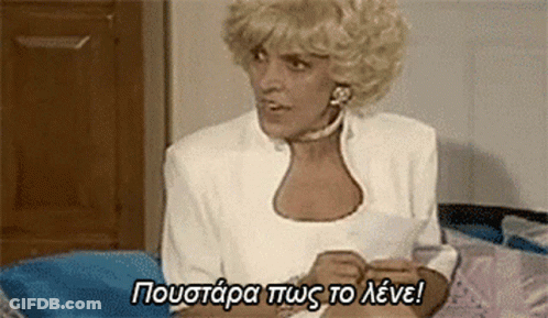 Blonde Woman Sitting On Bed With Foreign Language Above GIF
