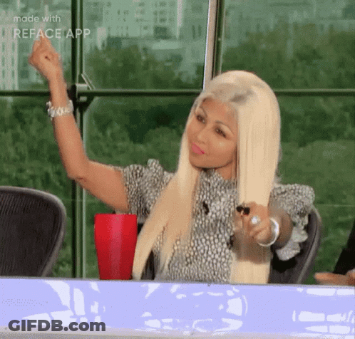 Blonde Woman Sitting With Fist In Air GIF