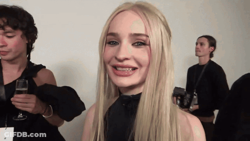 Blonde Woman Smiling Holding Glass Of Wine GIF