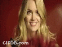 Blonde Woman Smiling Holding Red Heart GIF