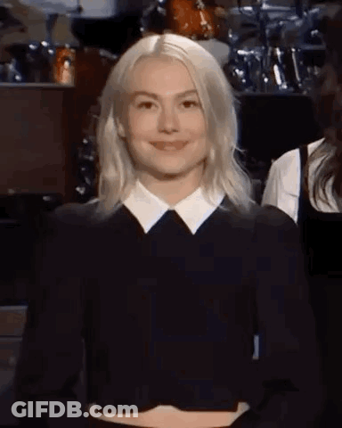Blonde Woman Smiling In Black Shirt And White Collar GIF