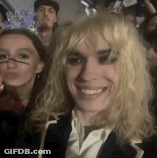 Blonde Woman Smiling In Crowd GIF