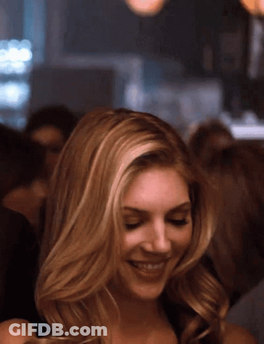 Blonde Woman Smiling In Crowd GIF
