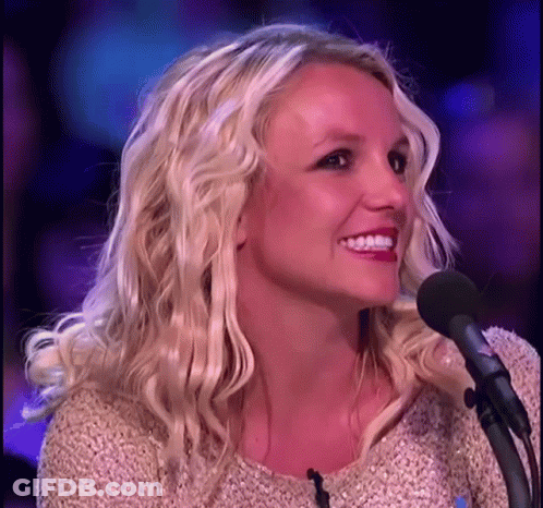 Blonde Woman Smiling Into Microphone GIF