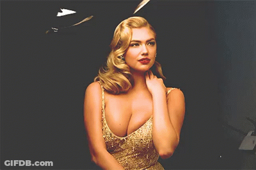 Blonde Woman Standing In Front Of Black Background GIF