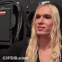 Blonde Woman Standing In Front Of Wall With Wires GIF