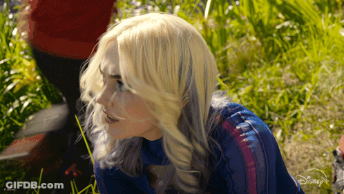 Blonde Woman Standing In Grass With Disney Logo GIF