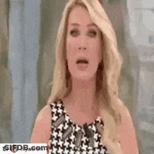 Blonde Woman Surprised In Black-And-White Dress GIF