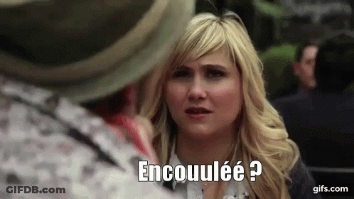 Blonde Woman Talking To Man In Hat Encouulée GIF