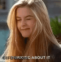 Blonde Woman Thinking And Smiling GIF
