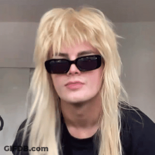 Blonde Woman Wearing Sunglasses And Mullet Wig GIF