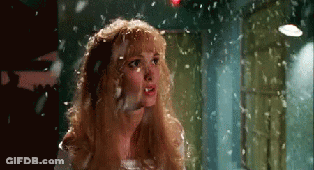 Blonde Woman With Feathers Falling On Head GIF