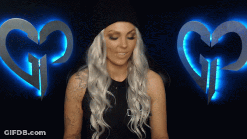 Blonde Woman With Tattoo And Two Glowing Hearts GIF