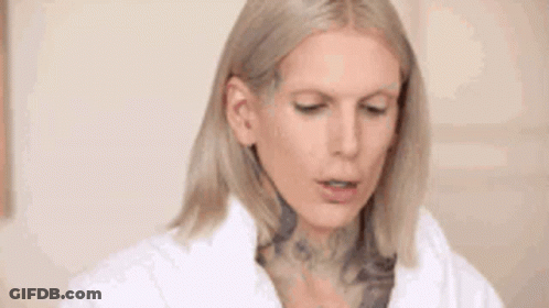 Blonde Woman With Tattoo In White Coat GIF